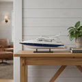 15" Unfinished Wood Hand Painted Model Boat styled in a furnished interior with a light gray wall on a wood floor in light gray wood.