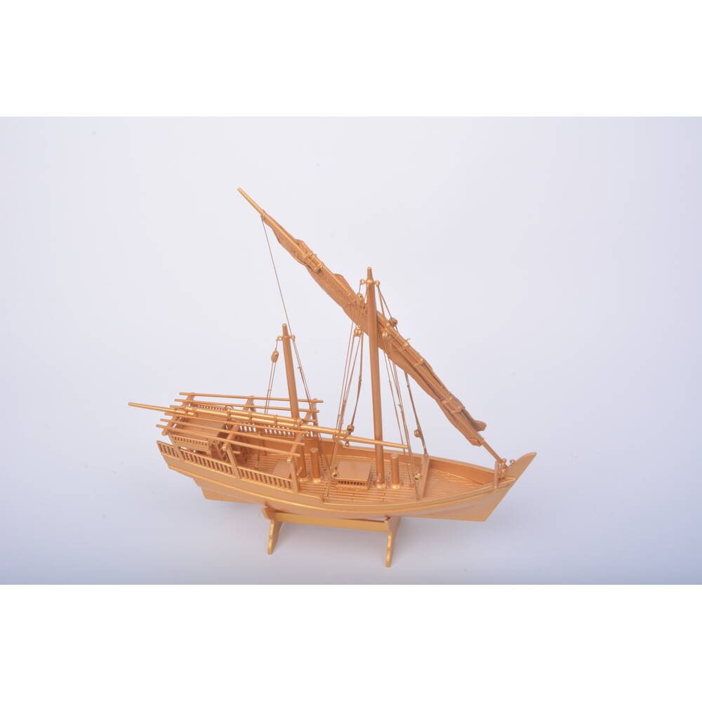 11" Unfinished Wood Hand Painted Model Boat. Home product isolated on a plain white background, showing a blue wood surface.