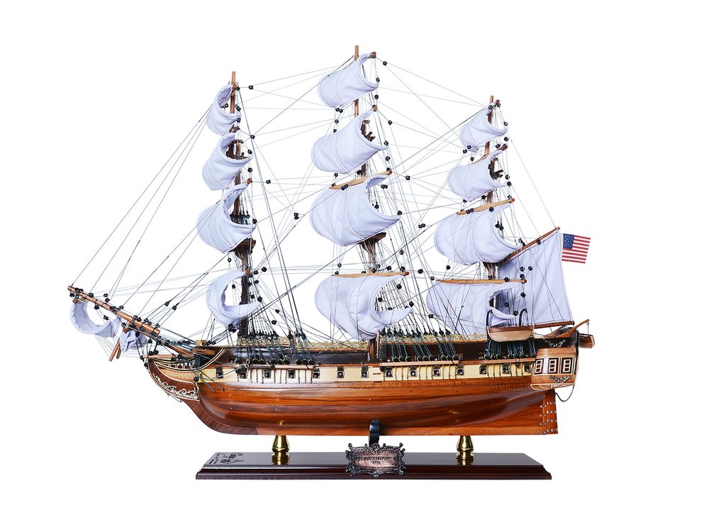 25" Unfinished Wood Hand Painted Model Boat. Home product isolated on a plain white background, showing a blue wood surface.