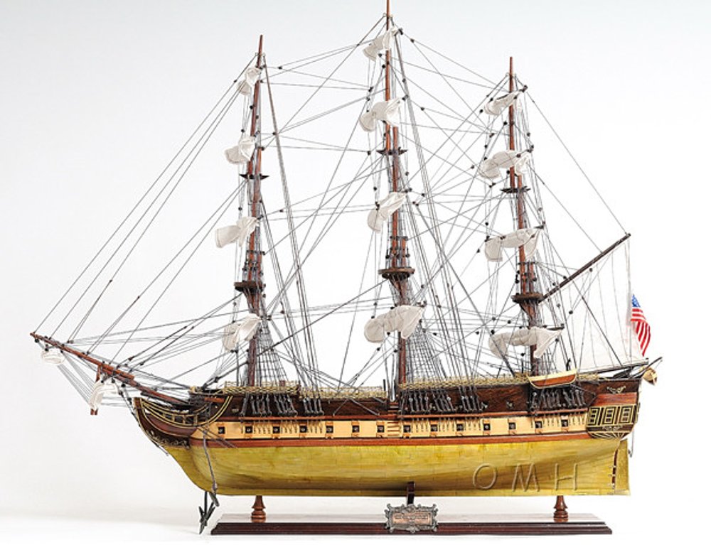 13" Unfinished Wood Hand Painted Model Boat. Home product isolated on a plain white background, showing a light gray wood surface.