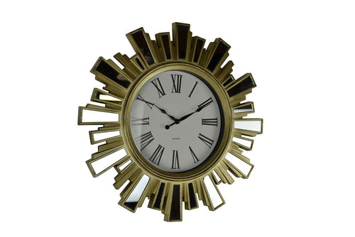 Gold sunburst wall clock with mirrored glass accents and Roman numerals on a white background.