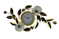Gold and white metal floral wall clock with analog display on a white background.