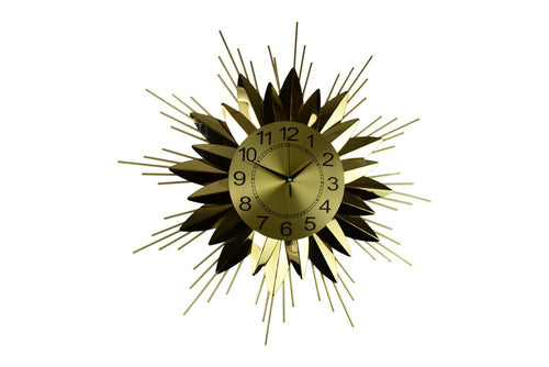 Gold and black metal sunburst wall clock with analog face on a white background.