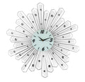 Silver and white metal sunburst wall clock with clear crystals on a white background.