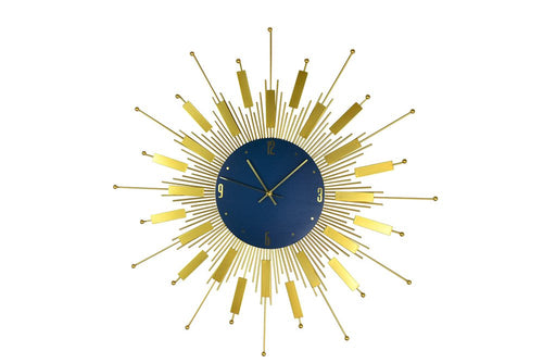 Gold and blue metal sunburst wall clock with analog face on a white background.