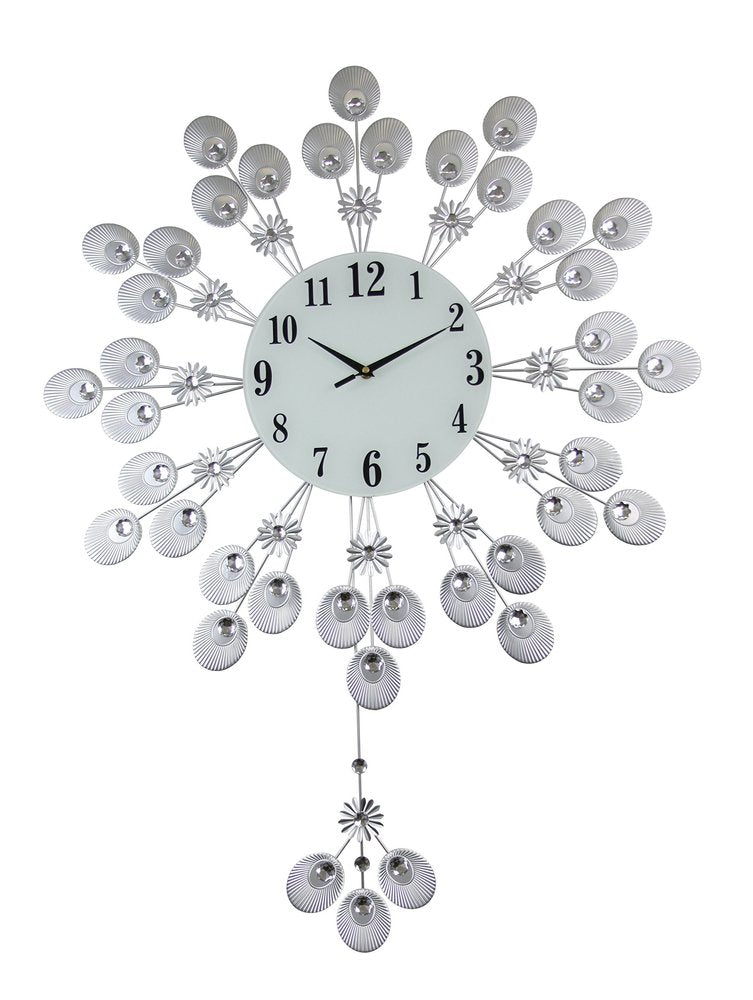 Silver and white metal starburst wall clock with a white face and black numbers, set against a white background.