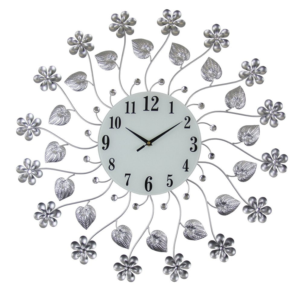Silver and white metal and glass floral wall clock with black numbers and hands on a white background.