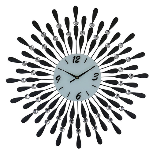A black and silver metal starburst wall clock with a white face and crystal accents on a white background.