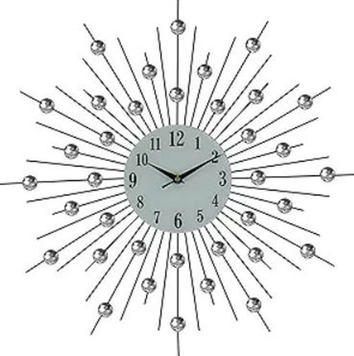 Black metal sunburst wall clock with clear crystal accents and a white analog face.