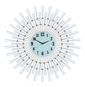 Silver and white metal sunburst wall clock with a light blue face and black numbers on a white background.