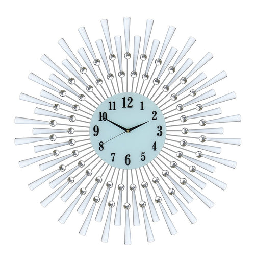 Silver and white metal sunburst wall clock with a light blue face and black numbers on a white background.
