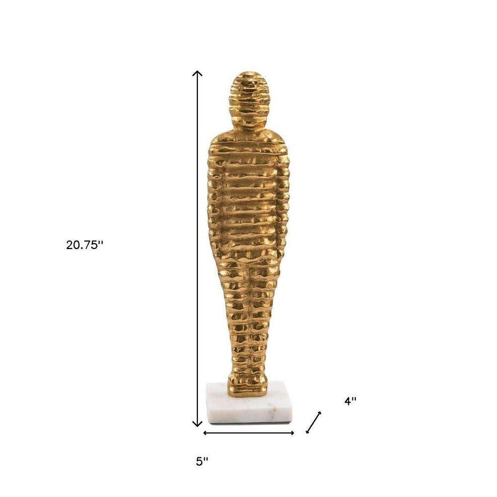 21" Gold And White Aluminum And Marble Mummy Tabletop Sculpture. Sculpture isolated on a plain white background, showing a gold metal surface.