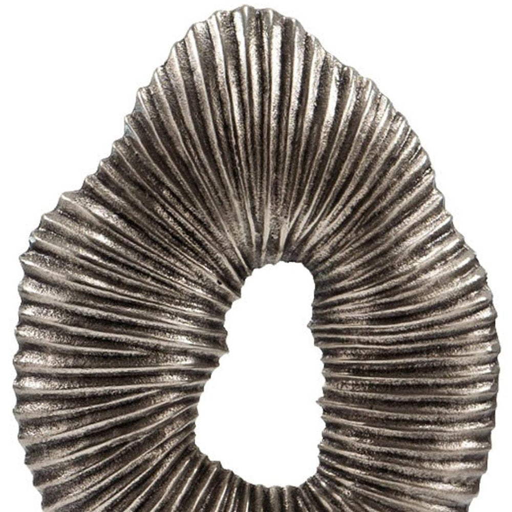 17" Silver And White Aluminum And Marble Tabletop Sculpture. Sculpture isolated on a plain white background, showing a metal surface.