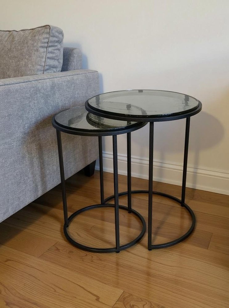 Set of Two Clear and Gunmetal Glass and Iron Round Frame Nested Tables in a home interior