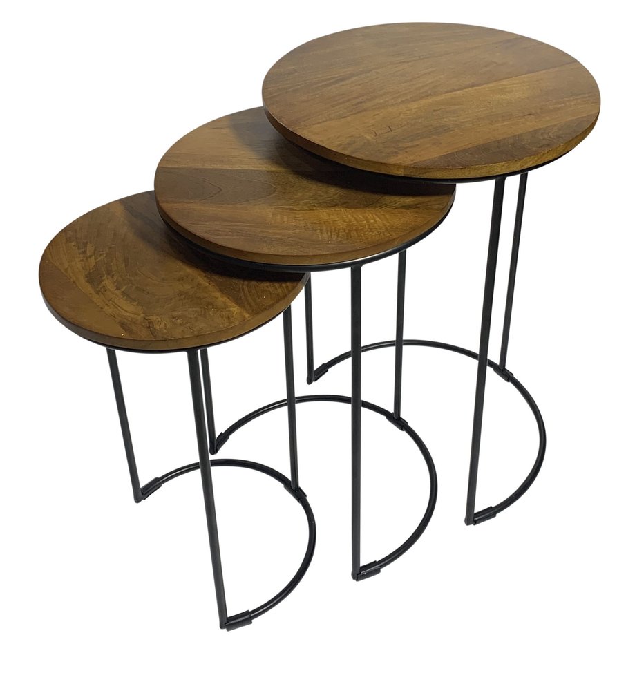 Set of three round wooden nesting tables with black metal frames and curved legs on a white background.