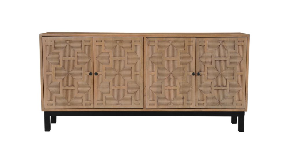 Brown solid wood sideboard with four carved geometric doors and black metal legs on a white background.