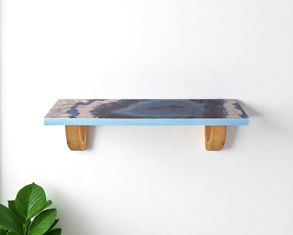 36" Blue And Natural Wood Agate Pattern Wall Mount Accent Shelf. Wall mounted shelve isolated on a plain white background, in a blue wood finish.