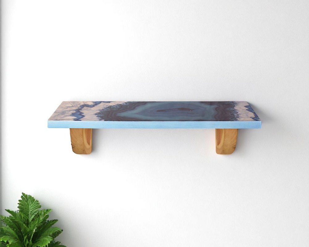 24" Blue And Natural Wood Agate Pattern Wall Mount Accent Shelf. Wall mounted shelve isolated on a plain white background, finished in gray wood.