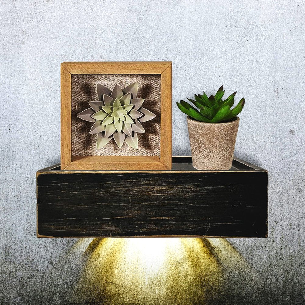 10" Black Distressed Wood Wall Mounted Floating Shelf With LED styled in a furnished interior with an off-white wall on a charcoal floor.