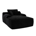 Black corduroy oversized chaise lounge chair with toss pillows on a white background.