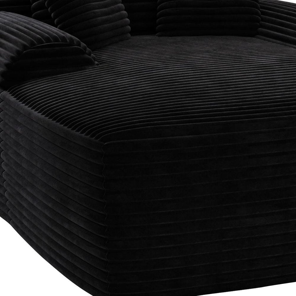 67" Black Corduroy Oversized Chaise Lounge Chair And Toss Pillows photographed against a dark studio background in black.