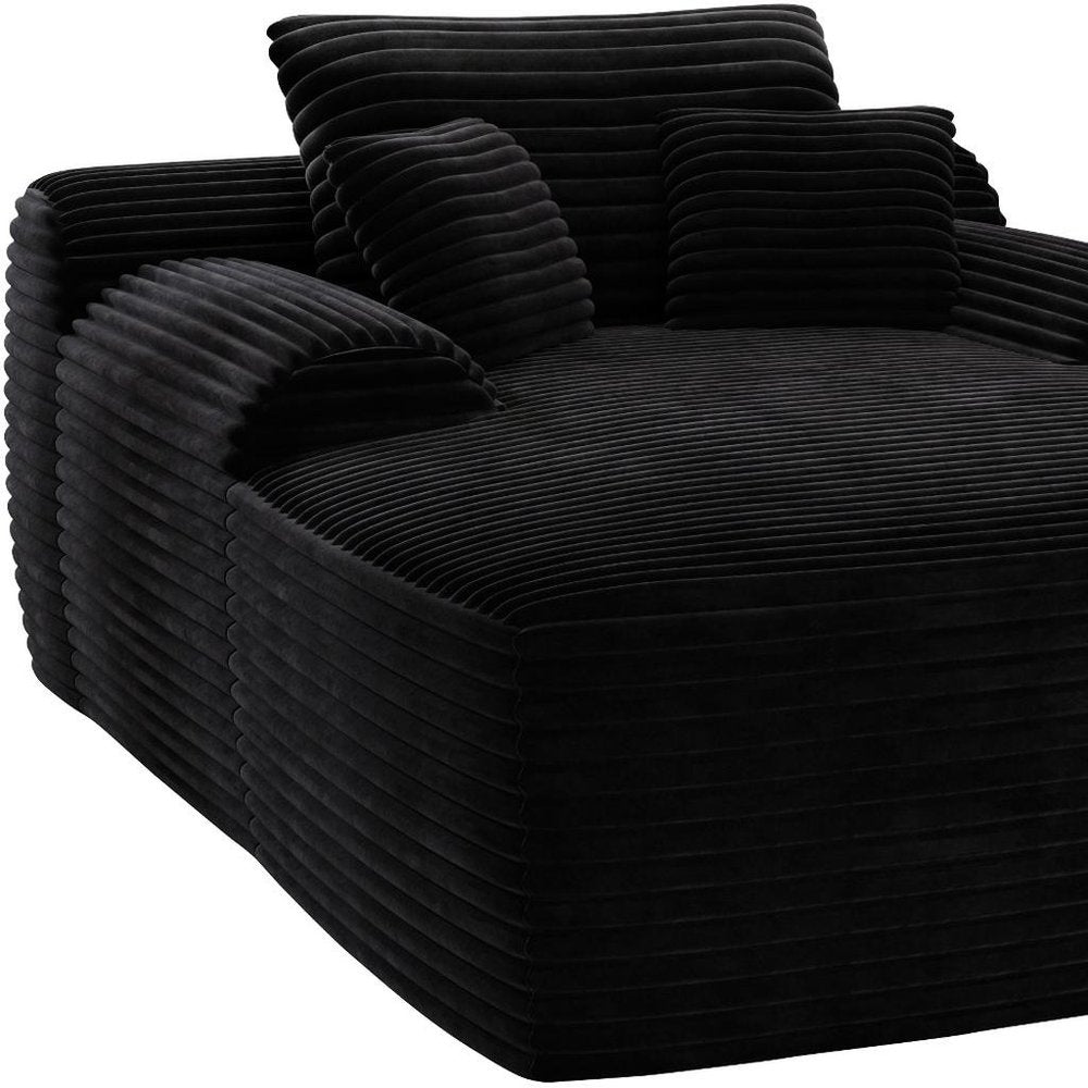 67" Black Corduroy Oversized Chaise Lounge Chair And Toss Pillows photographed against a dark studio background in black.