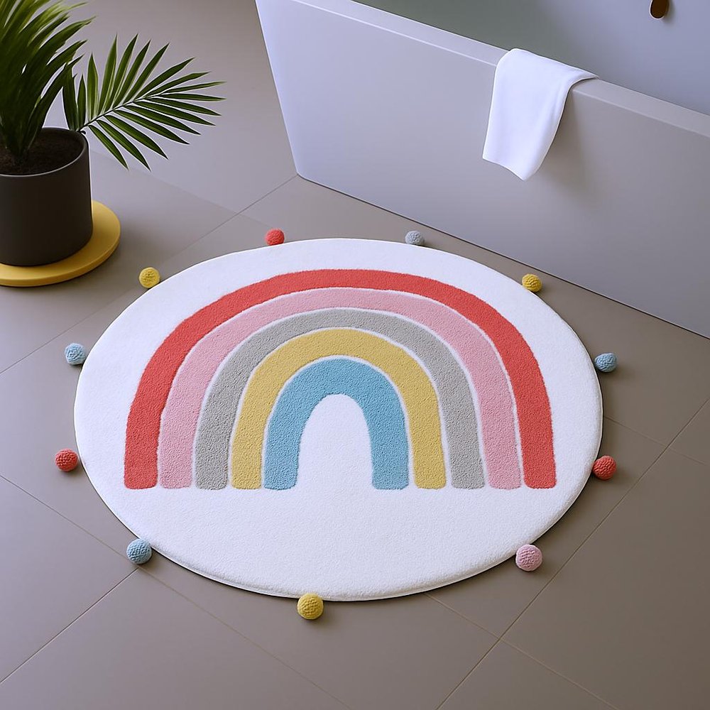32" White Pink And Yellow Cotton Rainbows Round Youthful Bath Rug shown outdoors on a tiled patio.