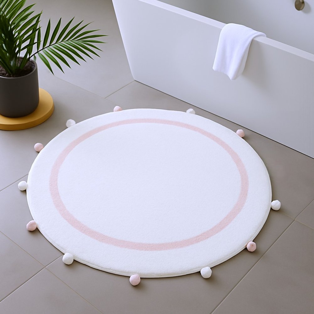 32" Light Pink And White Cotton Round Geometric Bath Rug shown outdoors on a tiled patio.