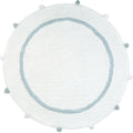 Round white cotton bath rug with a baby blue border and pom-pom accents on a white background.