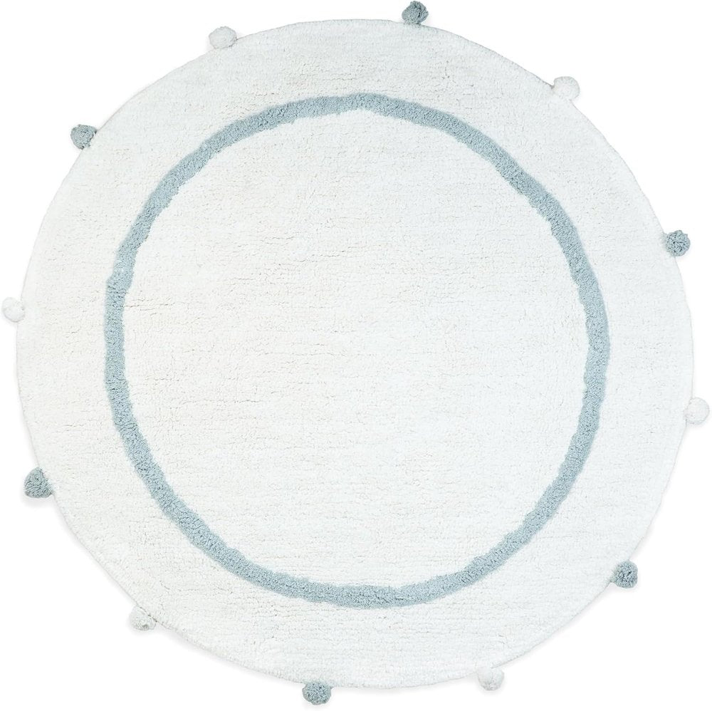 Round white cotton bath rug with a baby blue border and pom-pom accents on a white background.