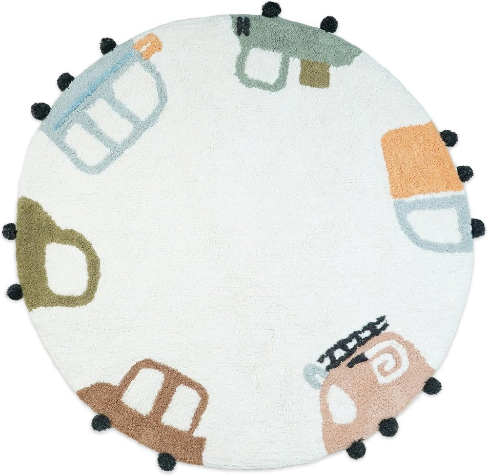 Round white bath rug with colorful cartoon cars and black pom-pom trim.