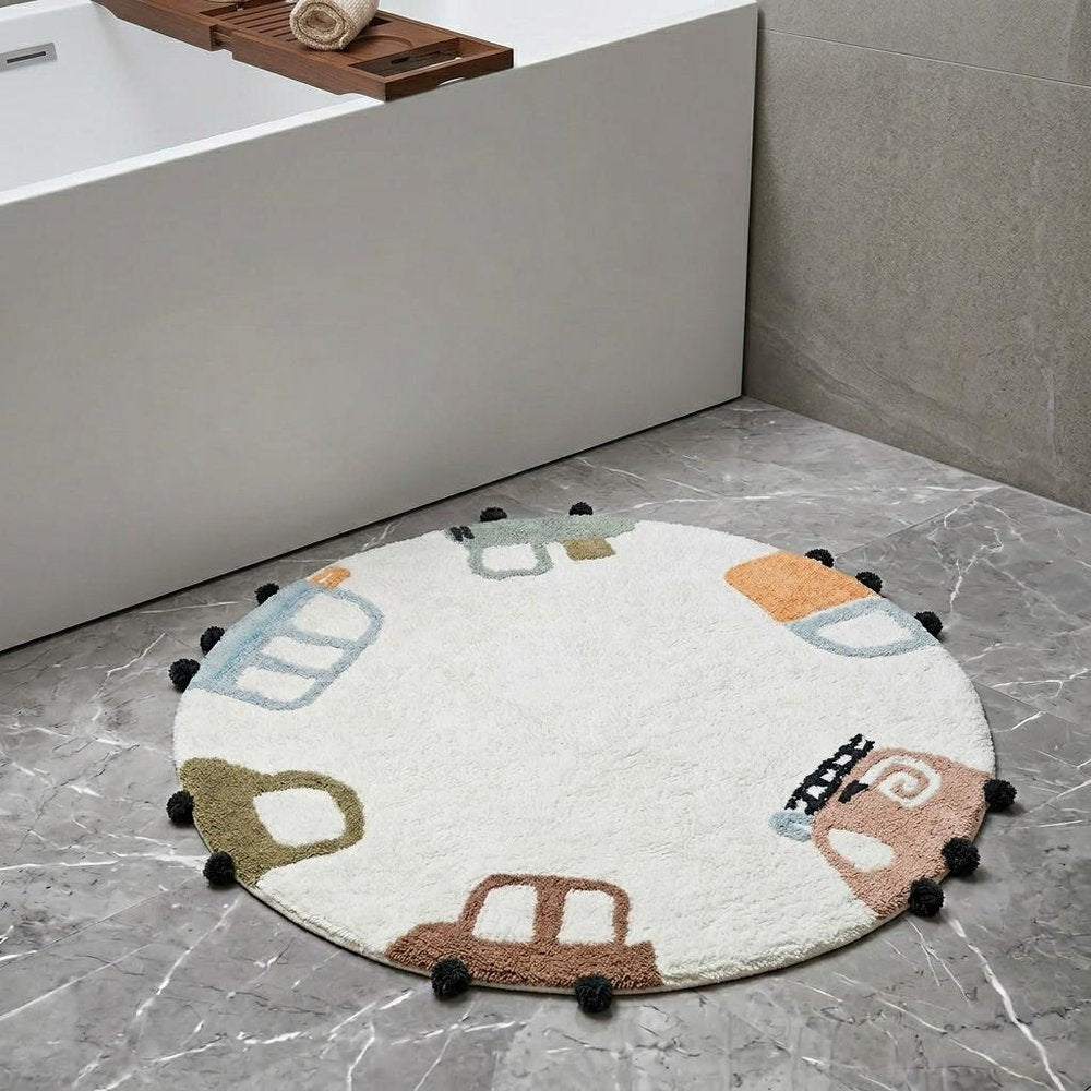 32" Blue Green And White Cotton Cars Round Youthful Bath Rug laid on a tiled floor in a furnished interior.