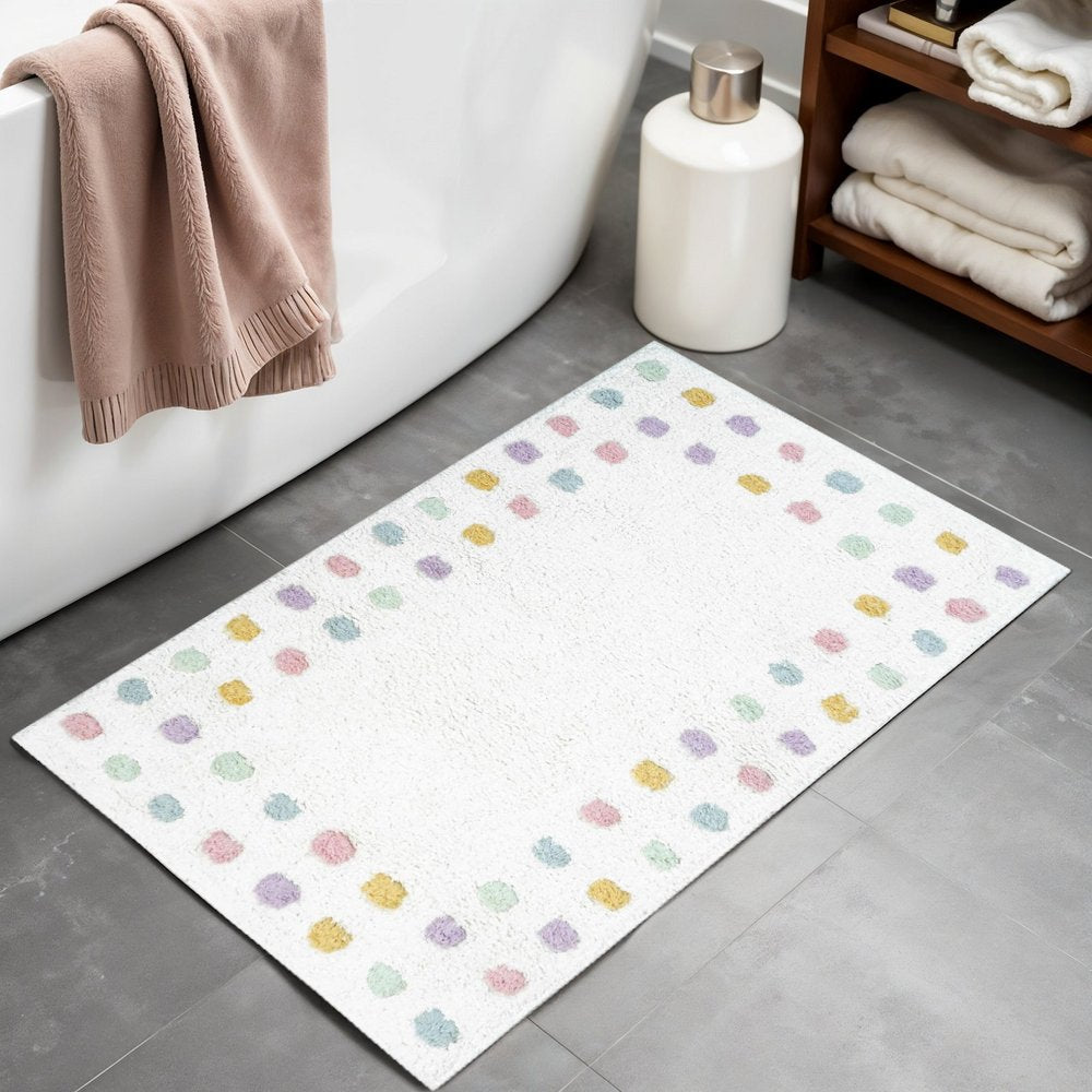 32" White Purple And Pink Cotton Polka Dots Bath Rug laid on a tiled floor in a furnished interior.