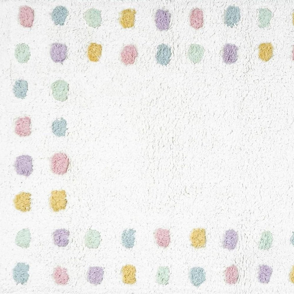 32" White Purple And Pink Cotton Polka Dots Bath Rug. Bath rug isolated on a plain white background, showing a white cotton surface.