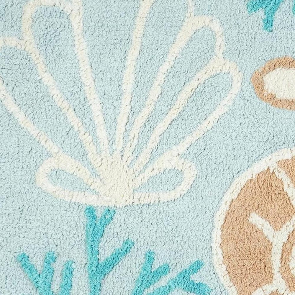 32" Blue Tan And White Cotton Seashells And Coral Bath Rug. Bath rug isolated on a plain white background, finished in white cotton.