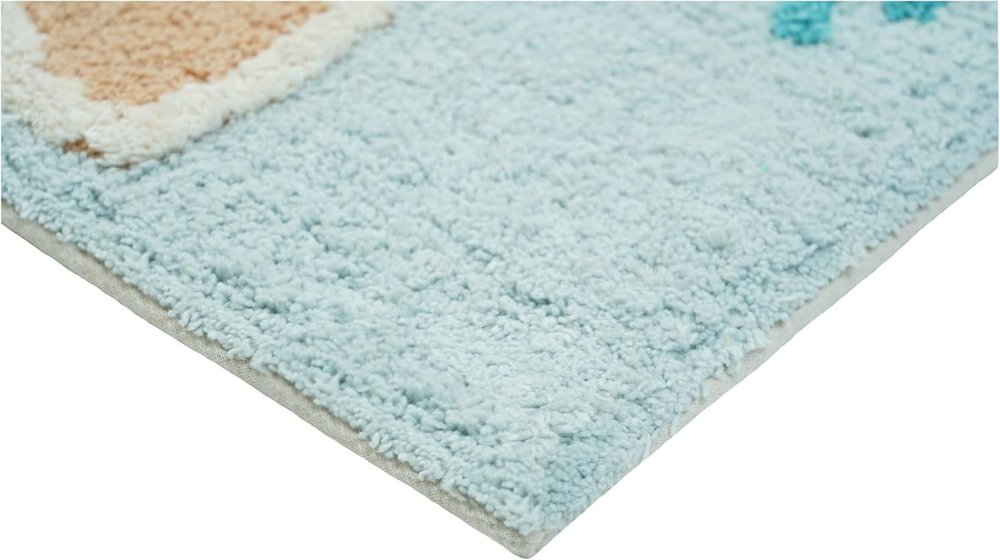 32" Blue Tan And White Cotton Seashells And Coral Bath Rug. Bath rug isolated on a plain white background, showing a white cotton surface.