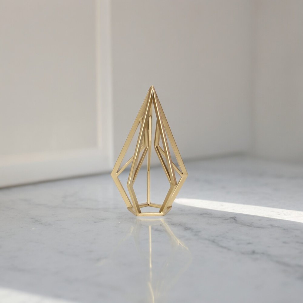 10" Gold Metal Open Geometric Tabletop Sculpture. Sculpture isolated on a plain white background, finished in gold metal.