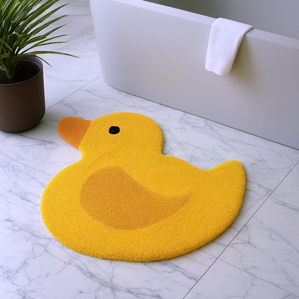 25" Yellow Cotton Rubber Duckie Youthful Bath Rug shown outdoors on an outdoor setting.
