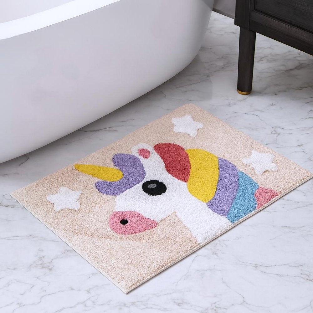 32" Pink And Yellow Cotton Unicorns Youthful Bath Rug laid on a off-white floor in a furnished interior.