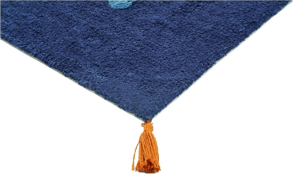Close-up of a blue shag bath rug with an orange tassel on a white background.