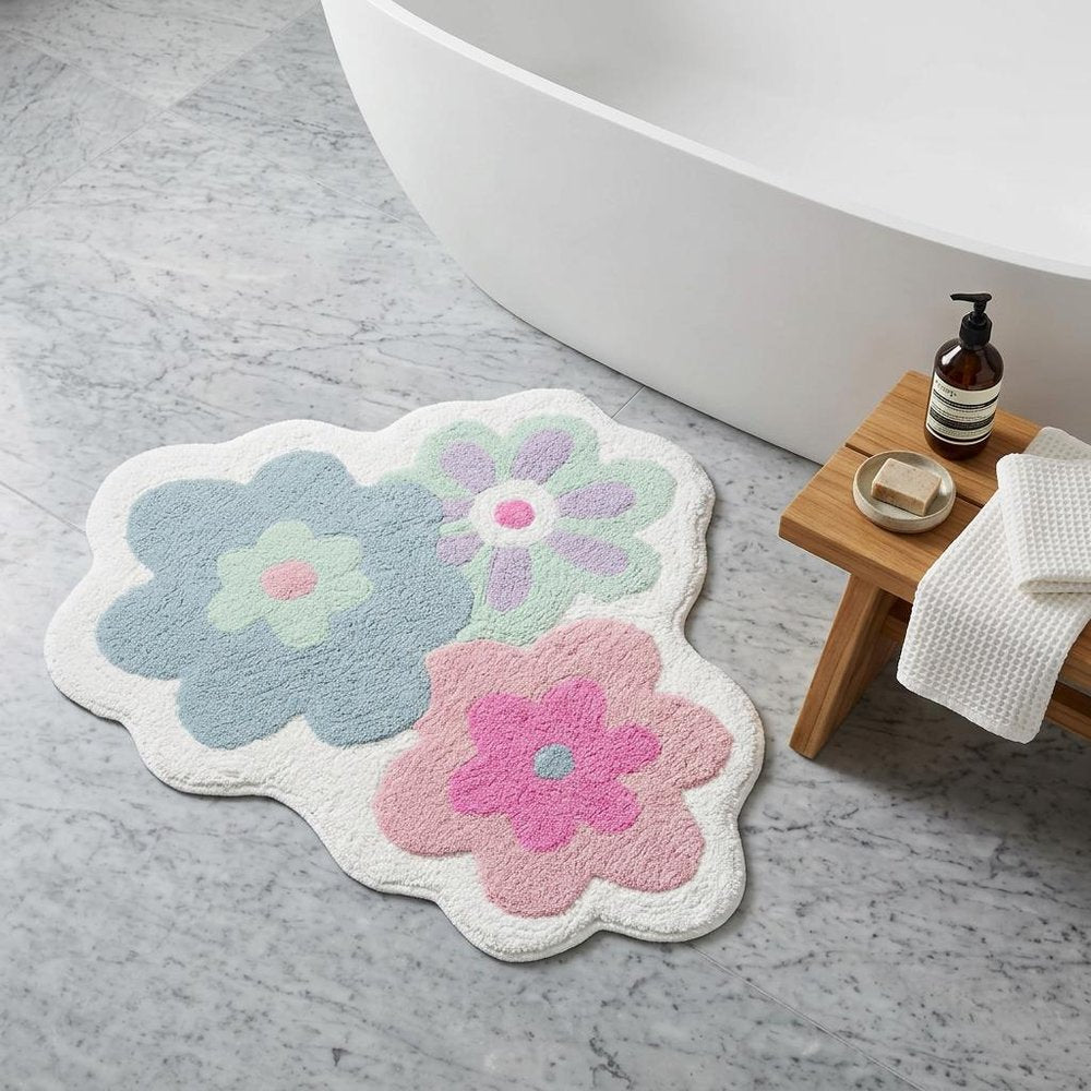 32" Pink And White Cotton Flowers Floral Bath Rug laid on a tiled floor in a furnished interior.