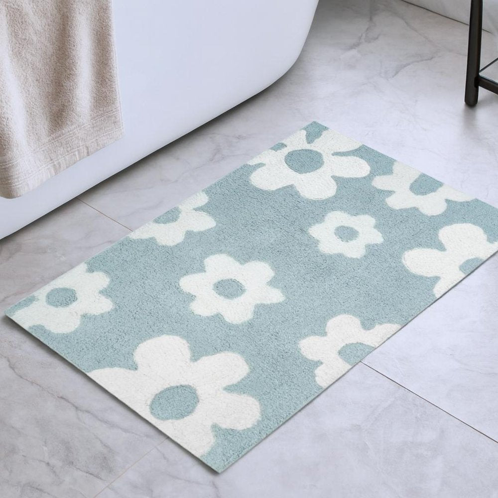 32" Blue And White Cotton Floral Bath Rug shown as a full-frame view of the light gray and off-white surface.