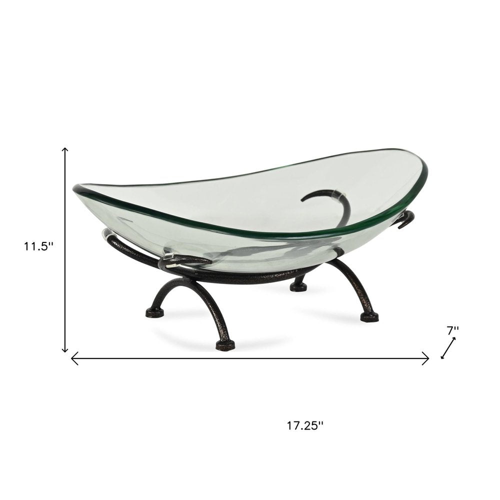 17" Clear And Black Glass And Metal Oval Decorative Bowl With Stand. Home product isolated on a plain white background, finished in clear glass.
