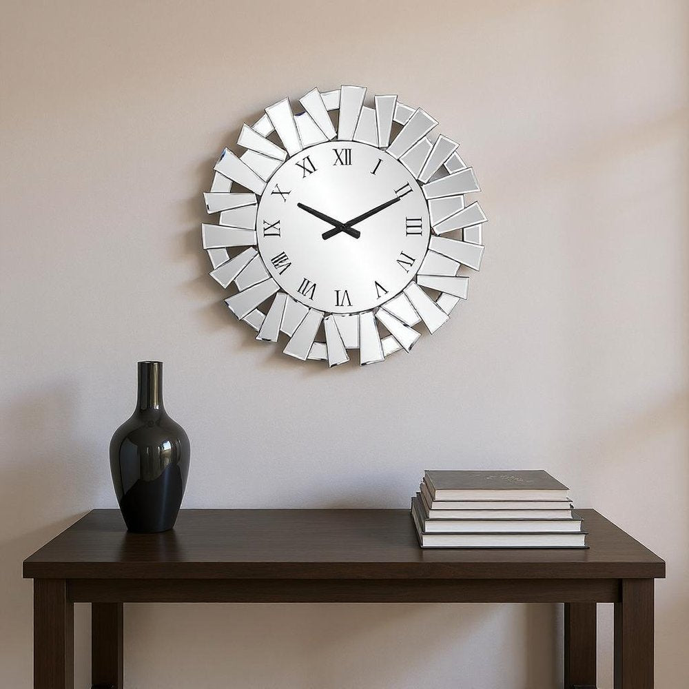 27" Silver Mirrored Glass Silent Analog Sunburst Wall Clock styled in a furnished interior with a cream wall on a dark wood floor.