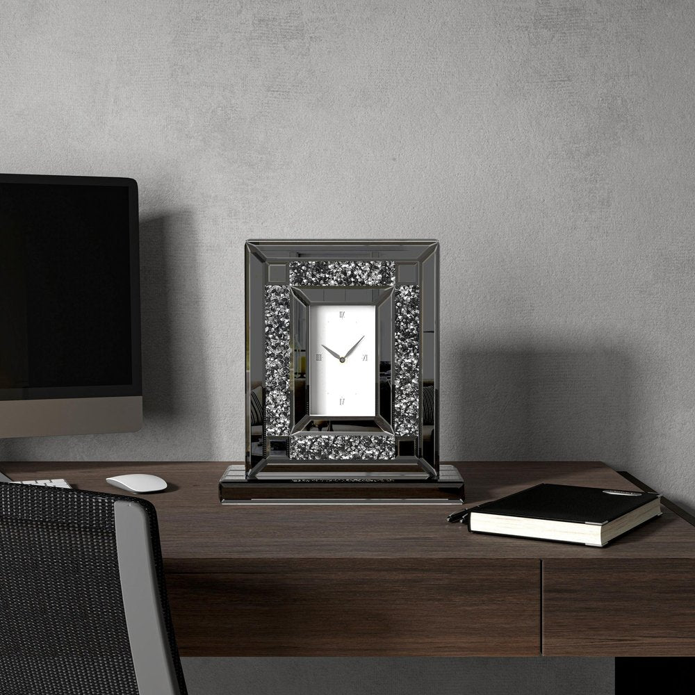 16" Silver And Black Faux Crystal And Mirrored Glass Table Clock styled in a furnished interior with a light gray wall on a dark wood floor.