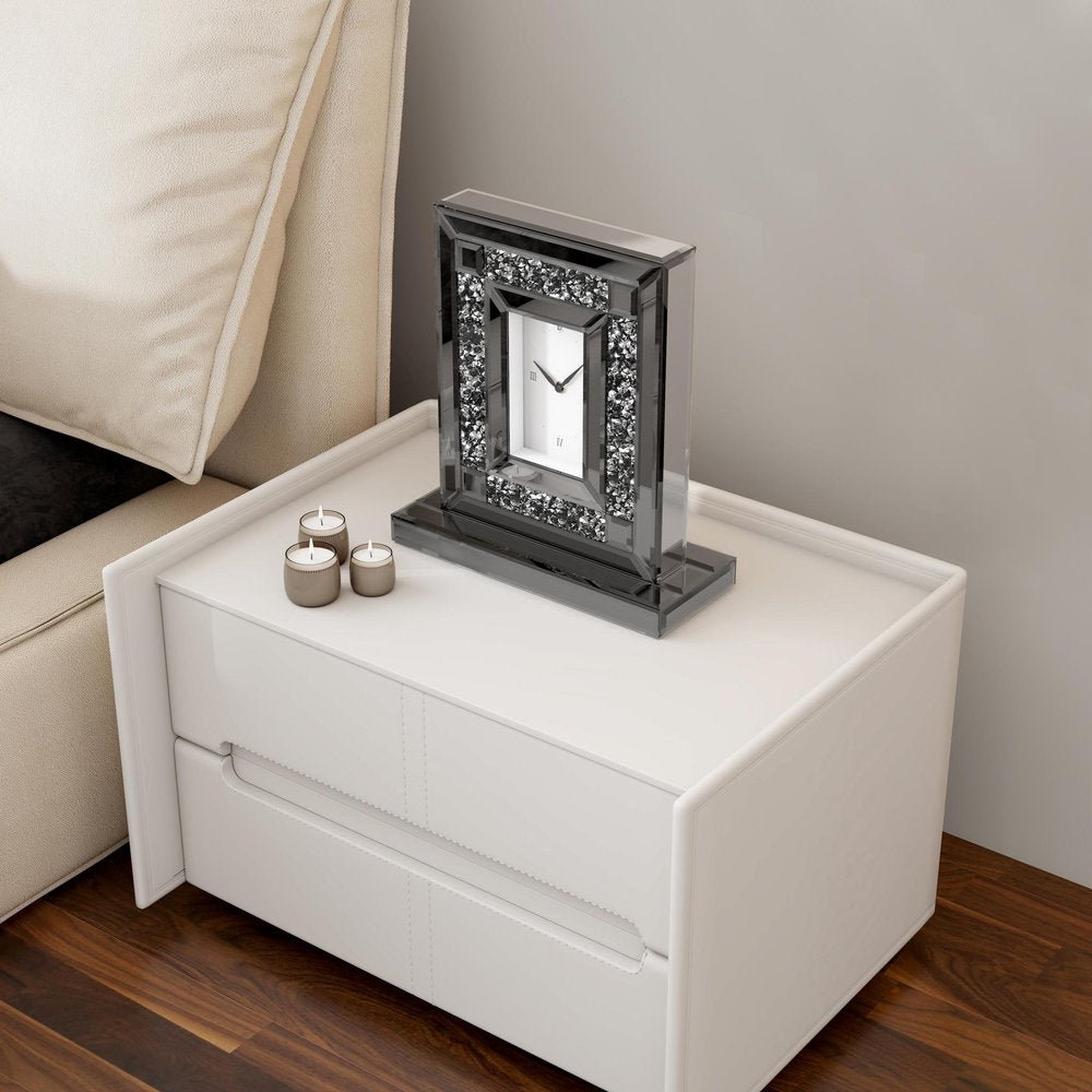 16" Silver And Black Faux Crystal And Mirrored Glass Table Clock styled in a furnished interior with a light gray wall on a dark wood floor.