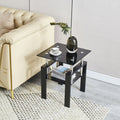 Set of Two Black Glass and Steel Square End Tables With Shelf on a white background