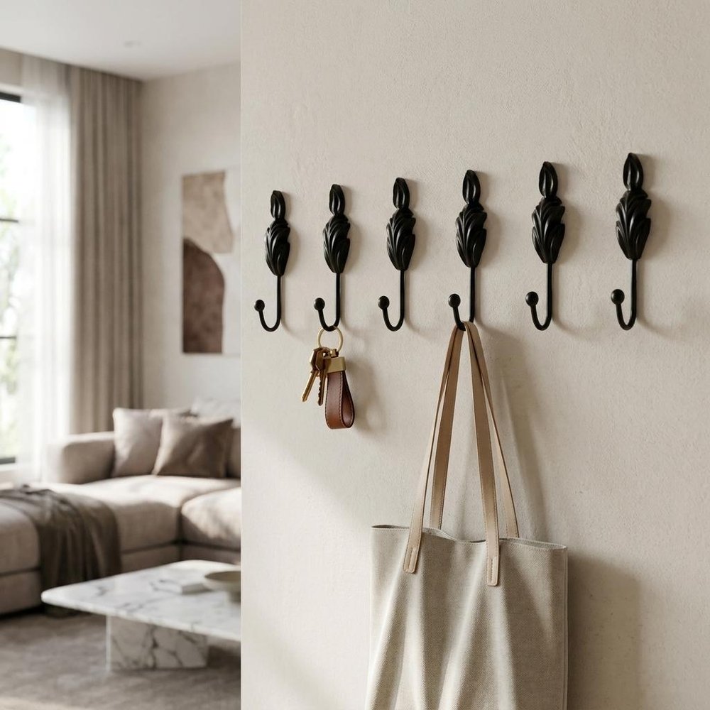 Set of Six Black Steel Feather Wall Hooks on a white background