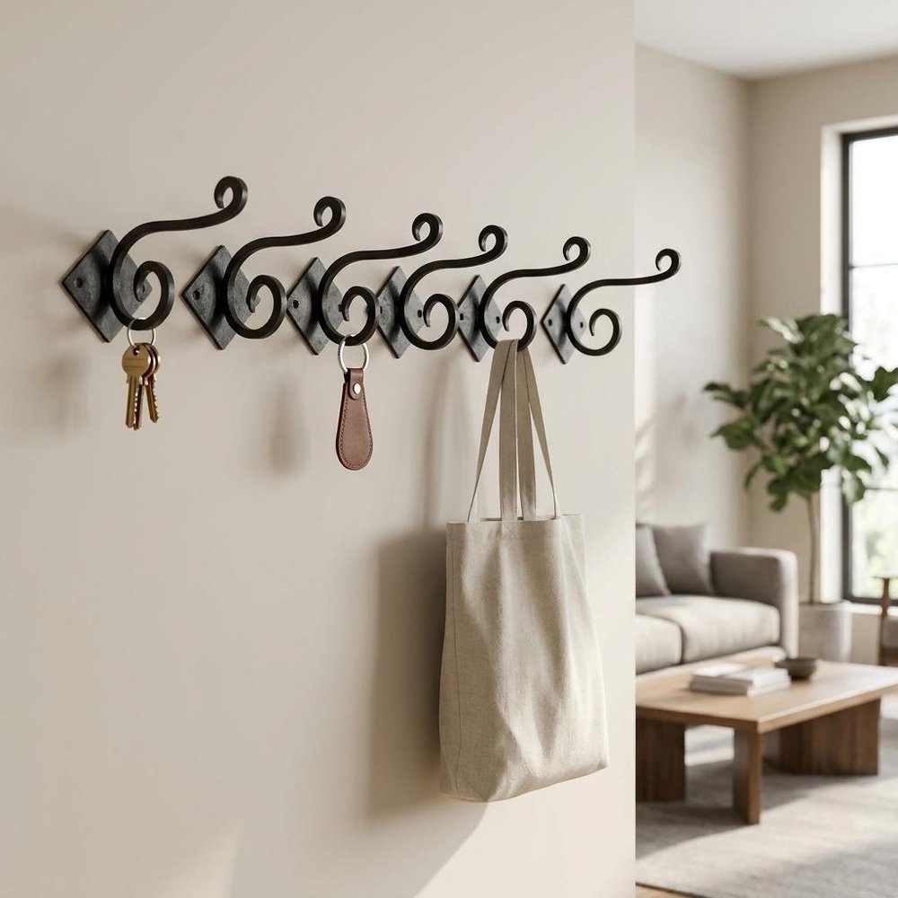 Set of Six Black Cast Iron Scroll Wall Hooks on a white background