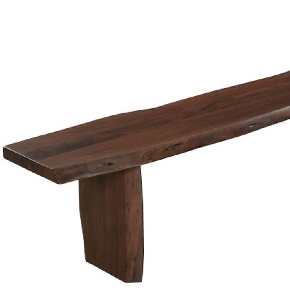 A brown solid wood live edge dining bench with a single leg on a white background.